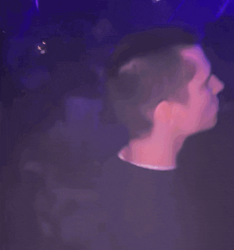 a blurry picture of a man 's face in a dark room