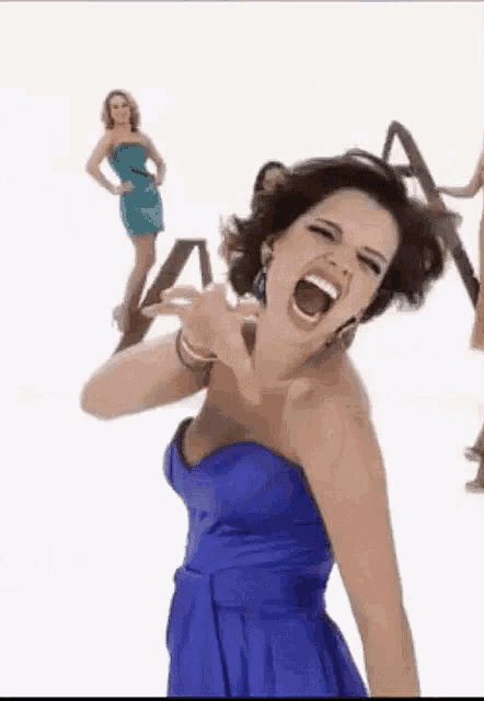 a woman in a blue strapless dress is screaming