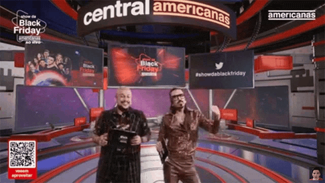 two men are dancing in front of a central americanas sign