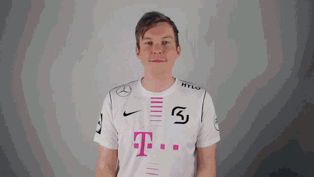 a man wearing a white t-mobile shirt is smiling