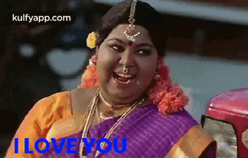 a woman in a purple saree is smiling and says `` i love you '' .