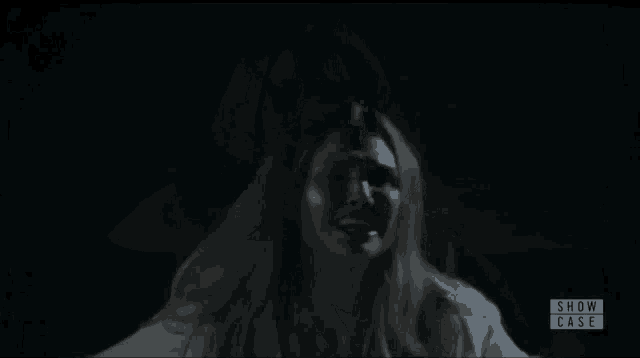 a woman in a white shirt with show case written on the bottom right