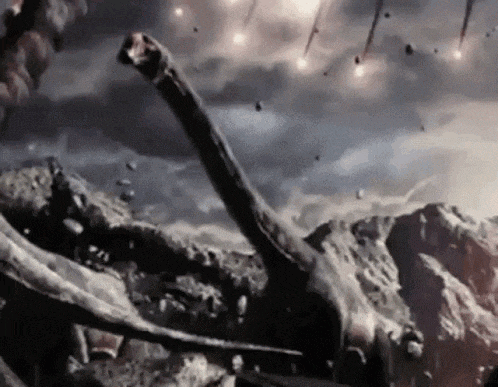 a dinosaur is laying on top of a rocky hill while asteroids fall in the sky .