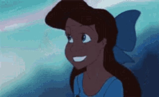 a close up of a cartoon girl with a blue bow on her head .