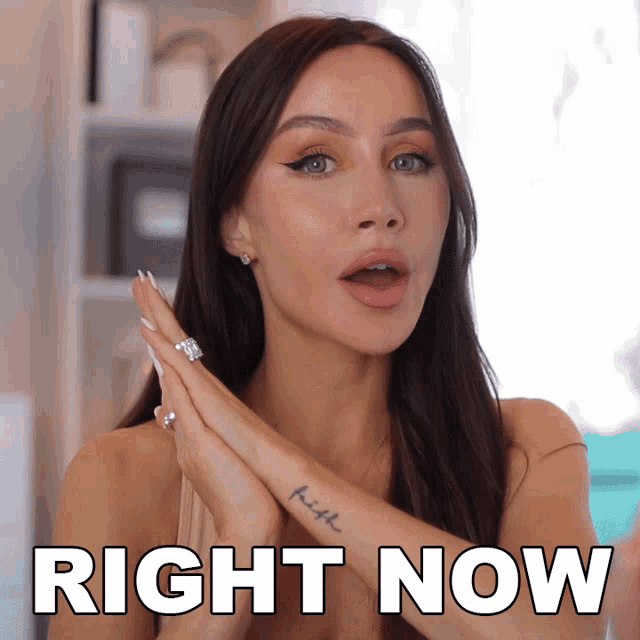 a woman with a tattoo that says faith on her arm says right now