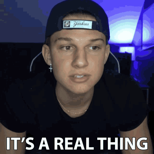 a young man wearing a yankees hat and a black shirt says it 's a real thing