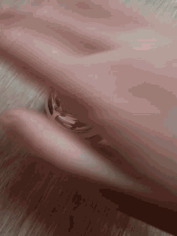 a close up of a person 's hands with a ring on their finger