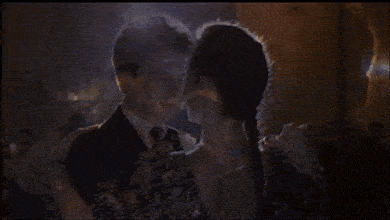 a man and a woman are dancing in the dark