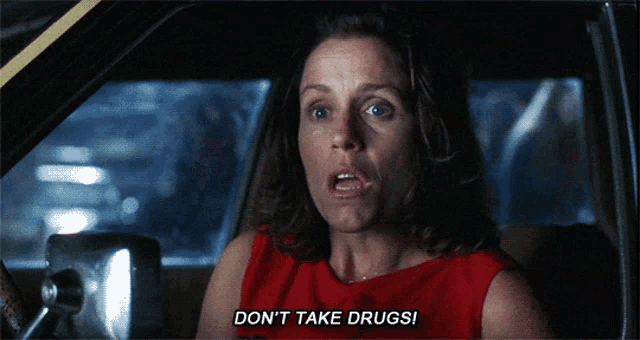 a woman in a red dress says " do n't take drugs " while sitting in a car