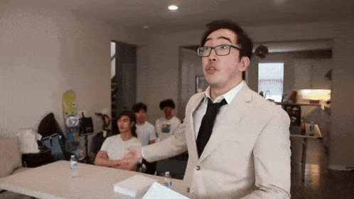 a man in a suit and tie is giving a speech