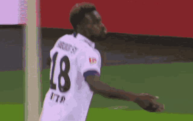 a soccer player with the number 18 on the back of his shirt