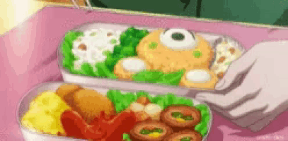 a person is holding a container of food on a table .