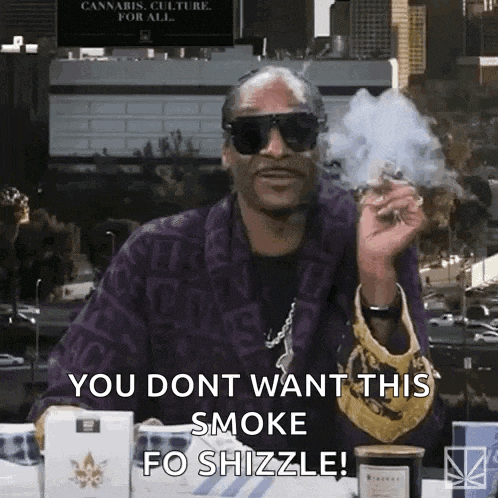 snoop dogg is wearing sunglasses and smoking a marijuana cigarette .