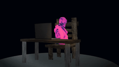 a pink skeleton is behind a laptop on a desk
