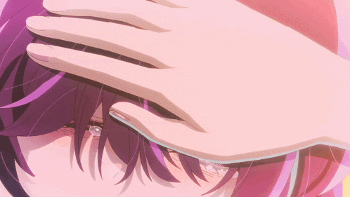 a close up of a person 's face with a hand on it
