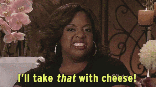 a woman is sitting on a couch and says i 'll take that with cheese