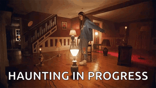 a woman is standing on a lamp in a room with the words haunting in progress above her