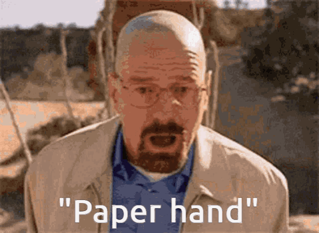 a man with glasses and a beard is saying paper hand