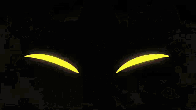 a cartoon cat with yellow eyes and sharp teeth is standing in a dark room .