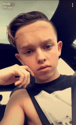 a young boy named jacob is taking a selfie