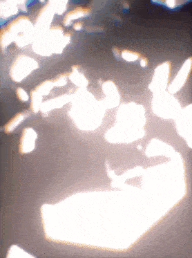 a blurry picture of a person 's face with a light shining on it
