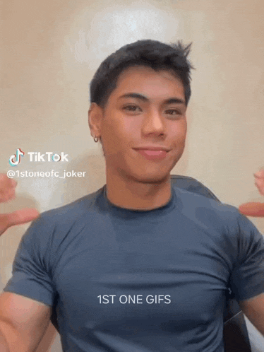 a young man wearing a blue shirt is making a funny face and says 1st one gifs