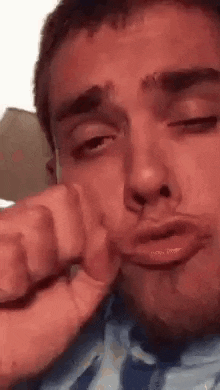 a close up of a man making a funny face with his mouth open .