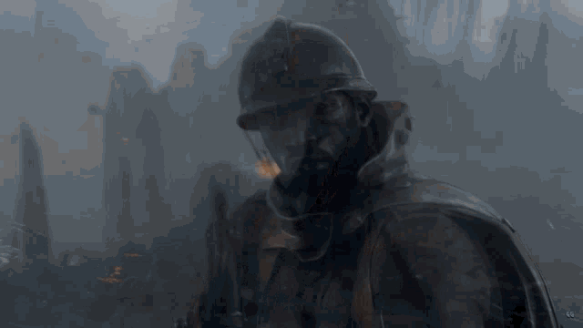 a man wearing a helmet and a gas mask stands in front of a blurred background