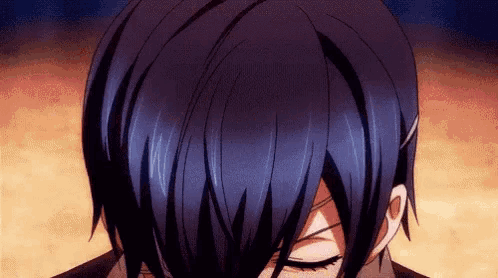 a close up of a person 's face with their eyes closed and their hair visible .