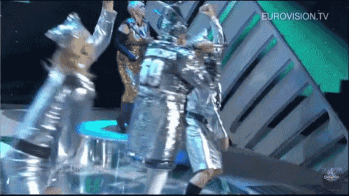 a group of people are dancing on a stage with eurovision.tv written on the bottom