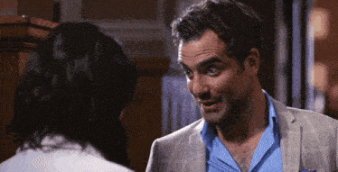 a man in a suit is talking to a woman