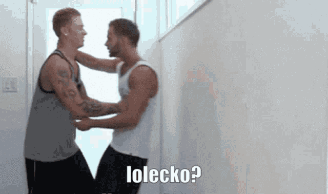 two men are standing next to each other and one of them is saying lolecko