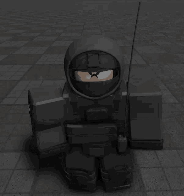 a black robot with a antenna on his head is standing in a dark room