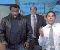 three men in suits and ties are dancing together in an office