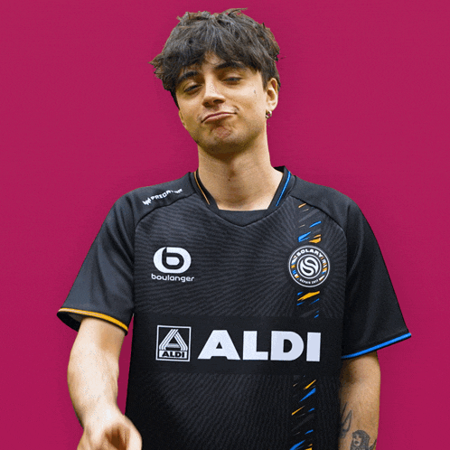 a man wearing a black shirt that says aldi on the front