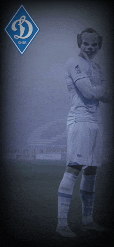 a soccer player wearing a clown mask stands in front of a logo for kiev