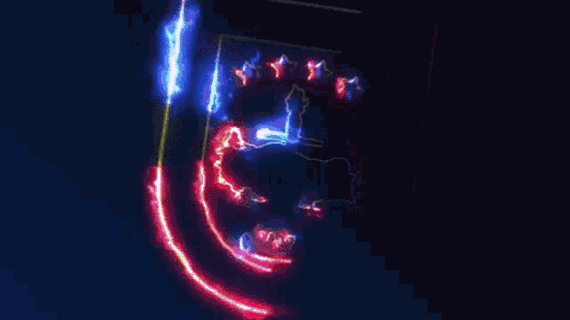 the letter u is glowing in the dark with a blue background .