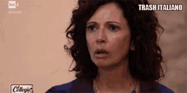 a woman with a surprised look on her face is on a television screen with the words trash italiano written below her