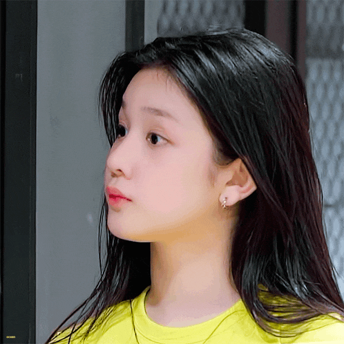 a close up of a girl 's face with a yellow background