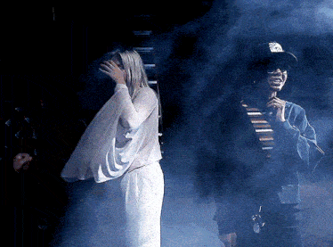 a man and a woman standing in a foggy room