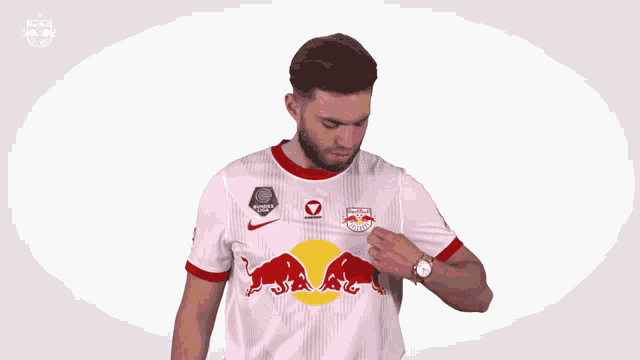 a man wearing a white red bull jersey