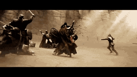 a group of soldiers are fighting each other in the sand