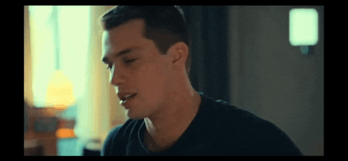 a close up of a man 's face with his eyes closed in a dark room .