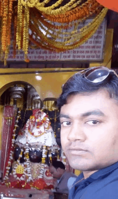 a man taking a selfie in front of a temple