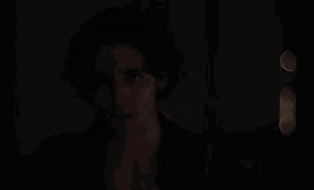 a close up of a man in a dark room