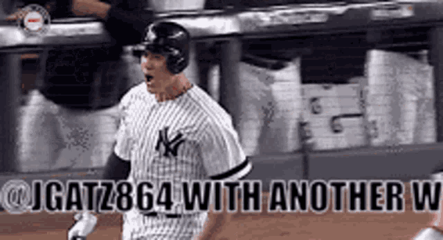 a man in a ny yankees uniform is standing on a baseball field .