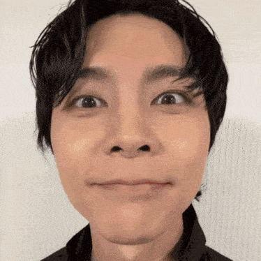 a close up of a young man making a face