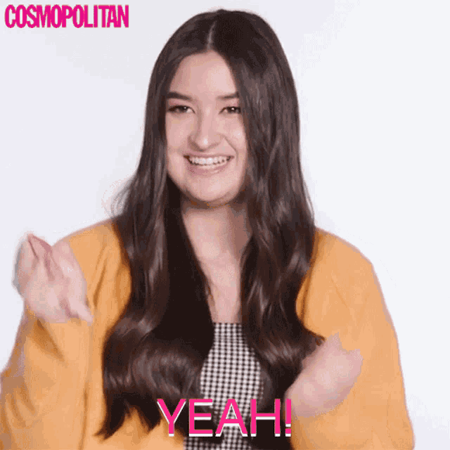 a woman in a yellow sweater says " yeah " in pink letters