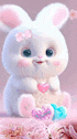 a white stuffed bunny rabbit is sitting on a pink blanket holding a pink heart .