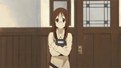 three anime girls are standing next to each other in a room . one of the girls has a book in her hand .